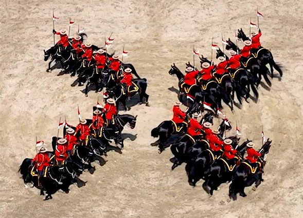 An aerial view of a Musical Ride performance with riders and horses 