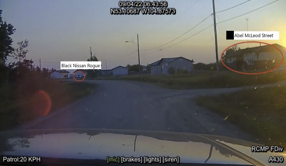 RCMP dash camera photo taken at 6:43 am on Abel McLeod Street where the Black Nissan Rogue is seen in the distance.