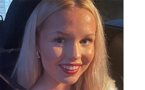 A portrait of a 17-year-old woman with long blonde hair and red lipstick.