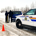 A cadet speaks to the driver of a crashed vehicle during a scenario.