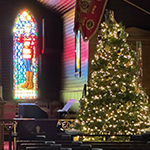 The RCMP Chapel around the holidays with stained glass windows and a holiday tree