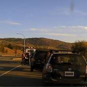A Toyota Matrix and a Jeep Liberty about to be towed on Highway #5. Two Approved Screening Device boxes are in the foreground