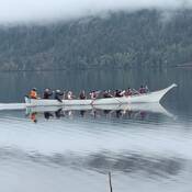 Paddlers with canoe “Reconciliation Queen” on Cultus Lake