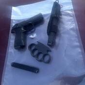 Image of brass knuckles, Airsoft gun, baton and drugs