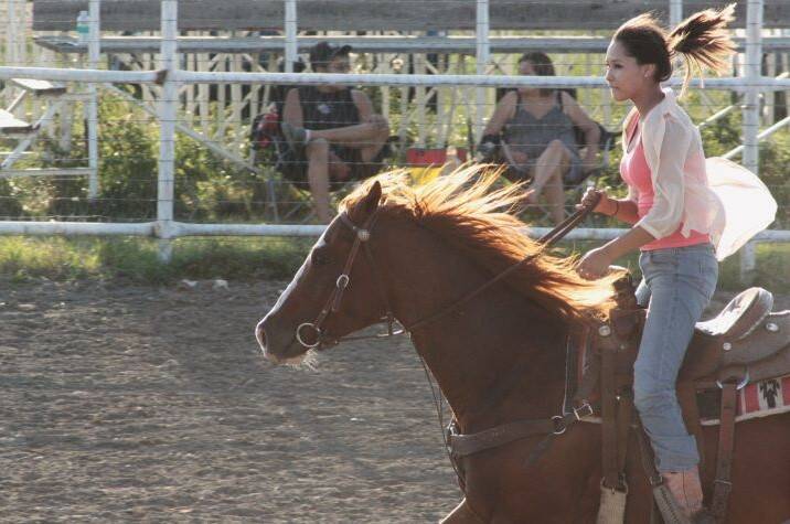 A young person riding on a horse.