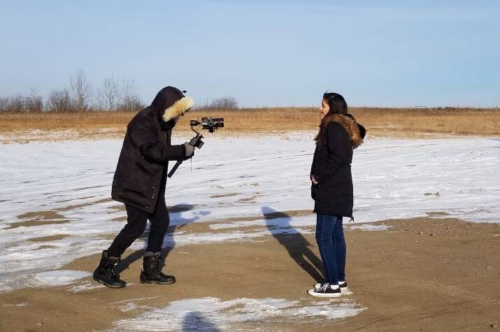 A girl is filmed as she sings.