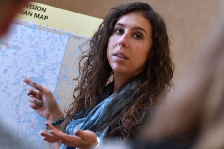Woman pointing at map.