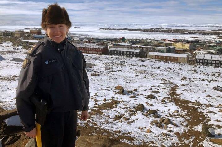 RCMP officer standing in fron of a community
