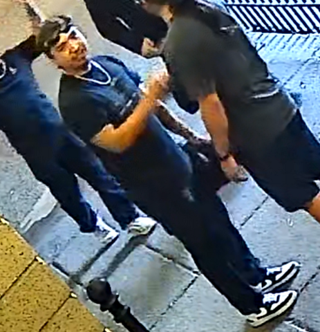 Man wearing black clothing and black and white shoes