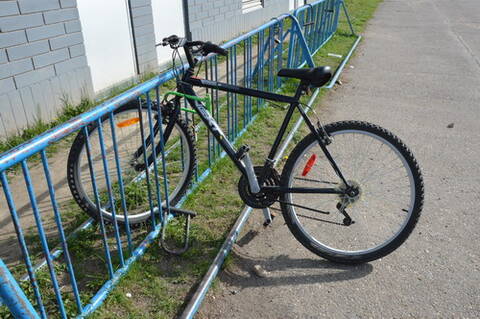 a bicycle locked to a stand