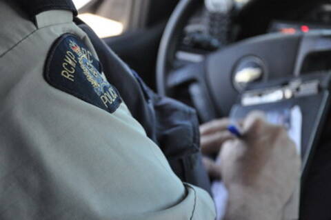 an officer writing a traffic ticket