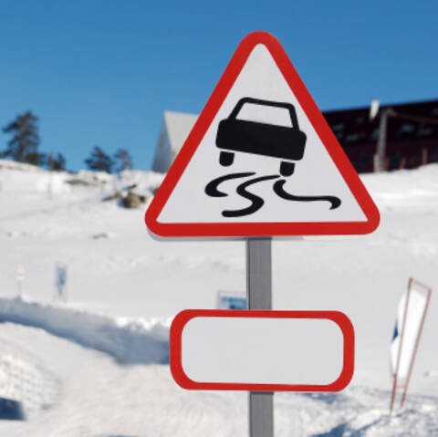 Road sign for slippery road